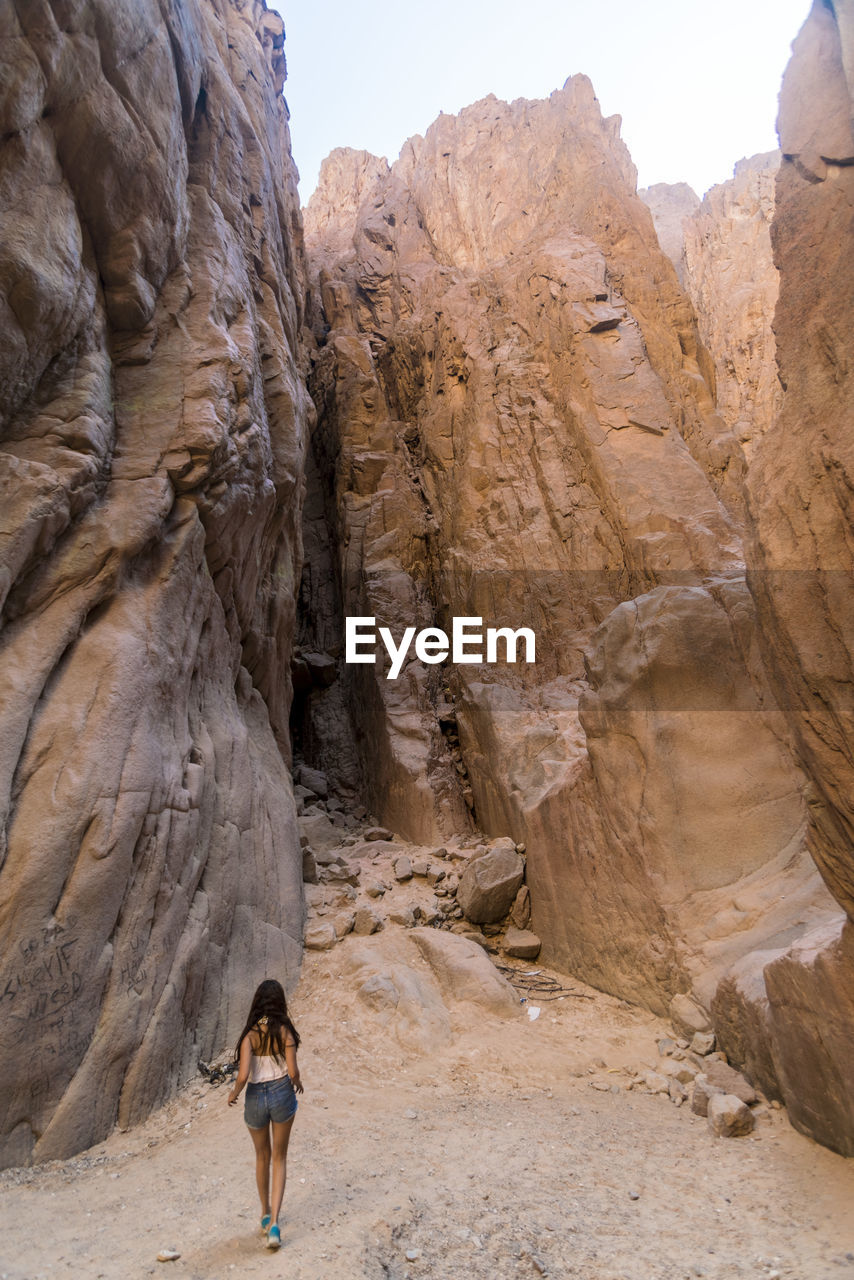 Young lady walking in the weshwash valley, south sinai mountain desert