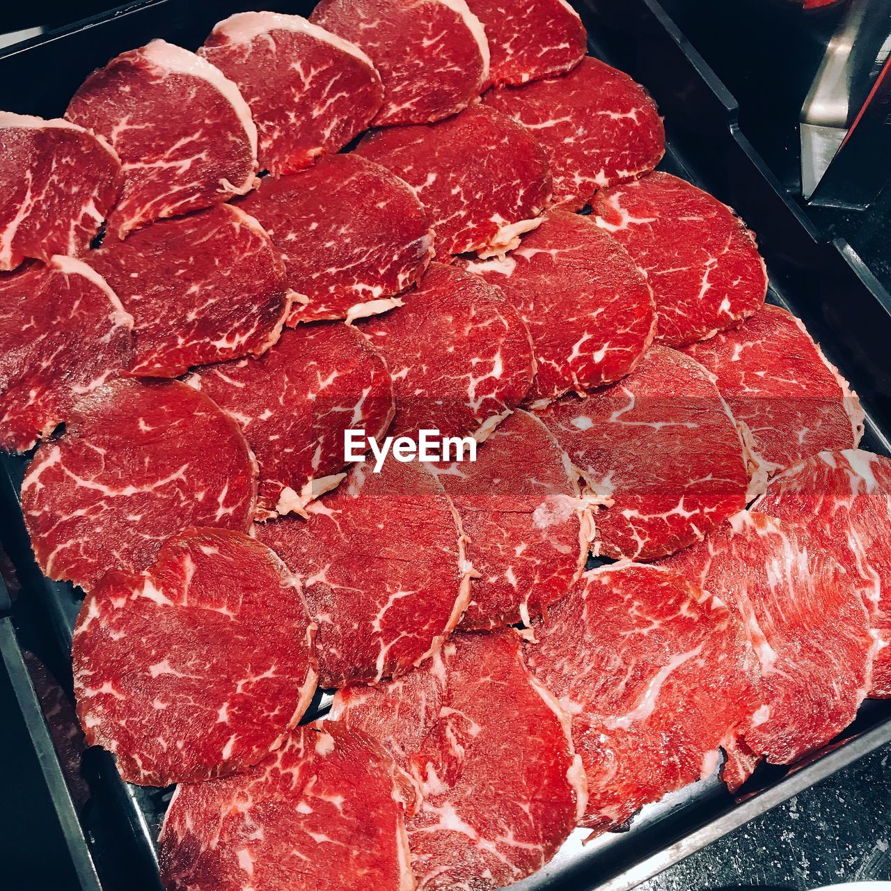 HIGH ANGLE VIEW OF RED MEAT IN CONTAINER