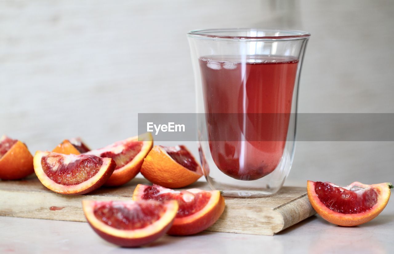 Close-up of cocktail with fruit slices on table