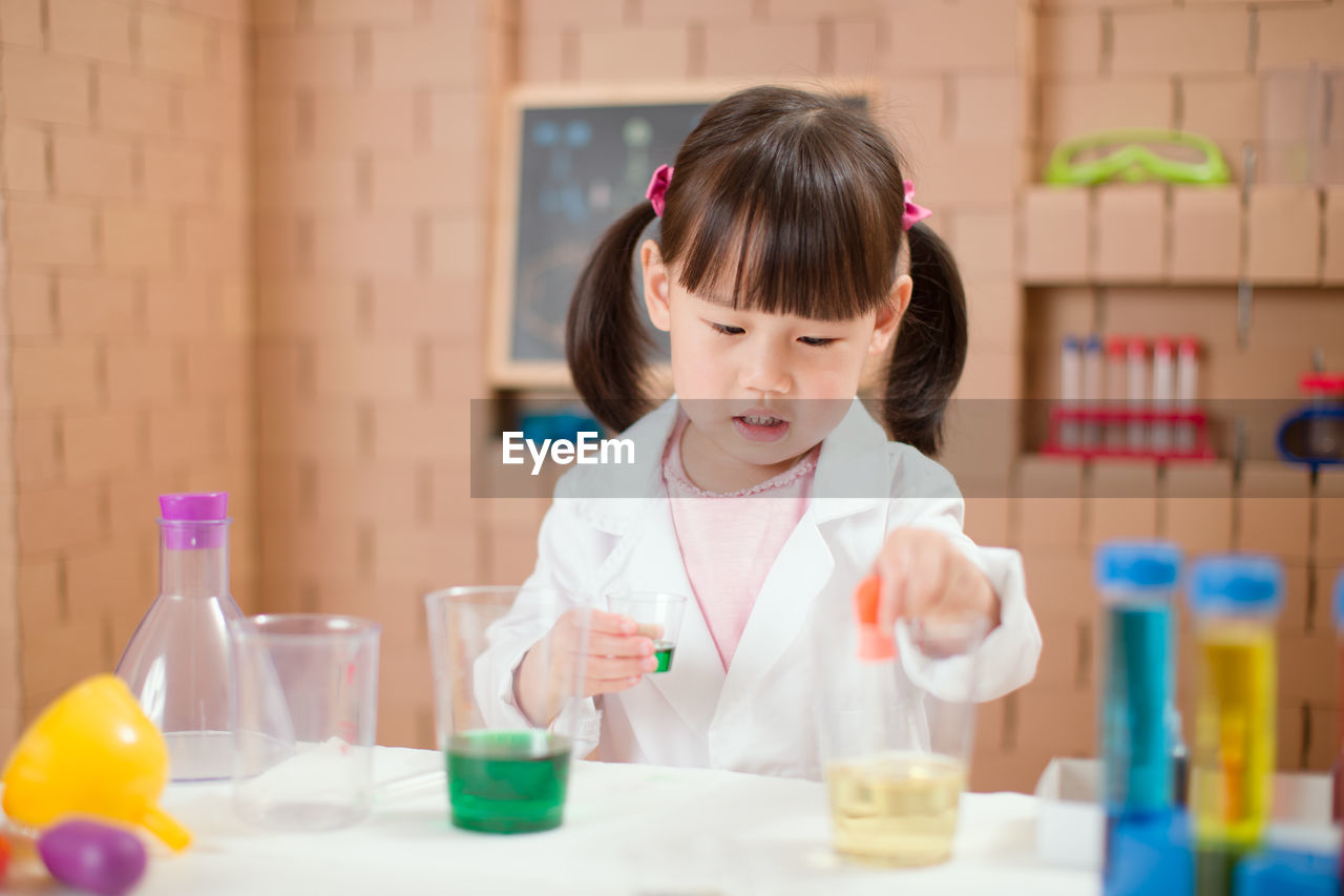 Young girl play science experiments for homeschooling