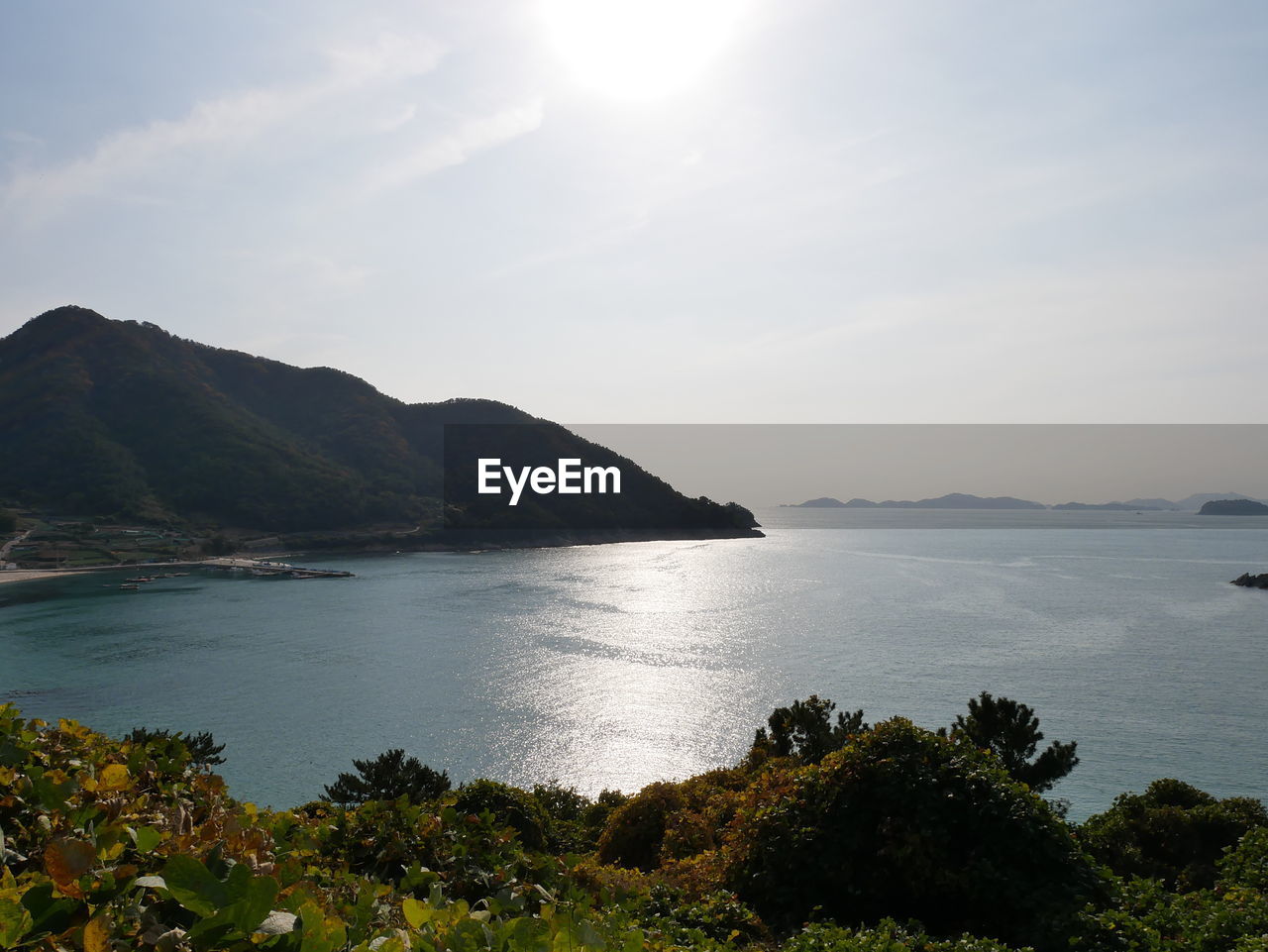 Scenic view of sea and mountains against sky