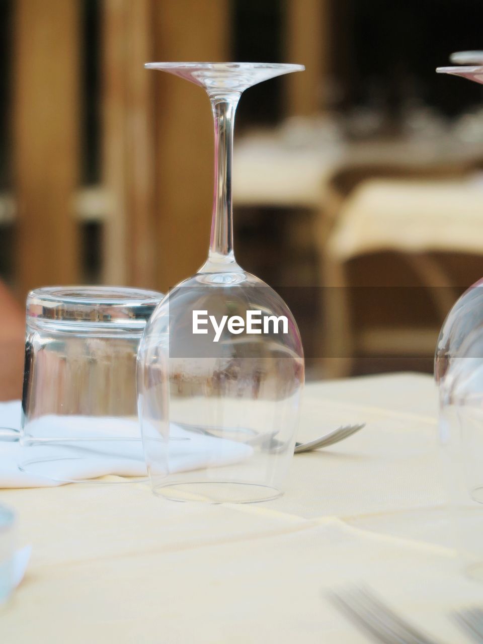 CLOSE-UP OF DRINKING GLASSES ON TABLE