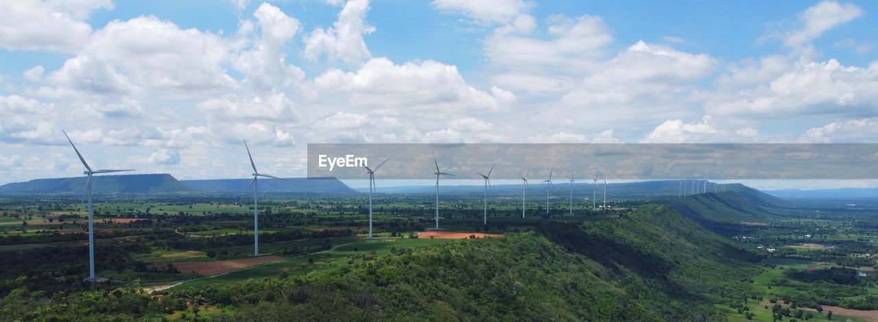 Wind turbine farm power generator in beautiful nature landscape for production of renewable