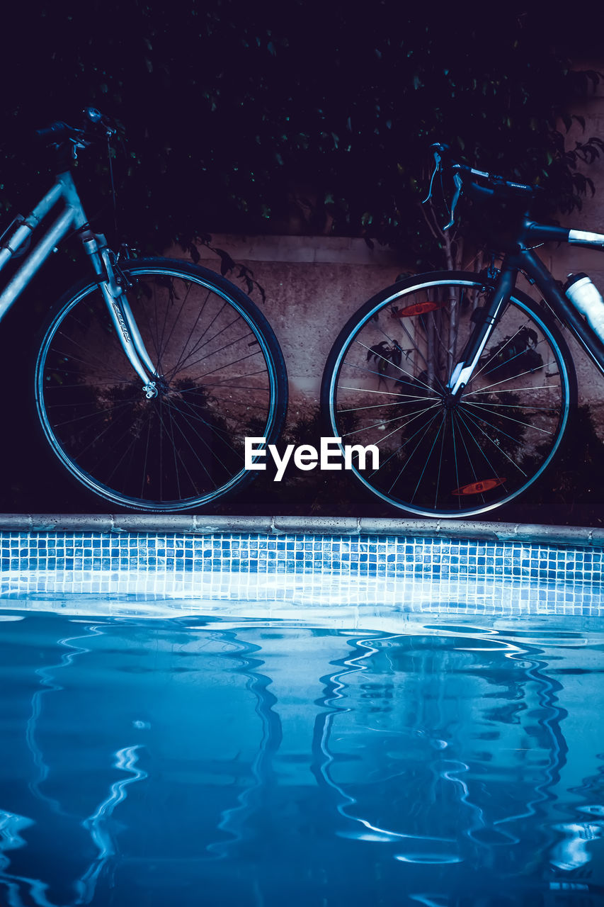 Reflection of bicycles on swimming pool