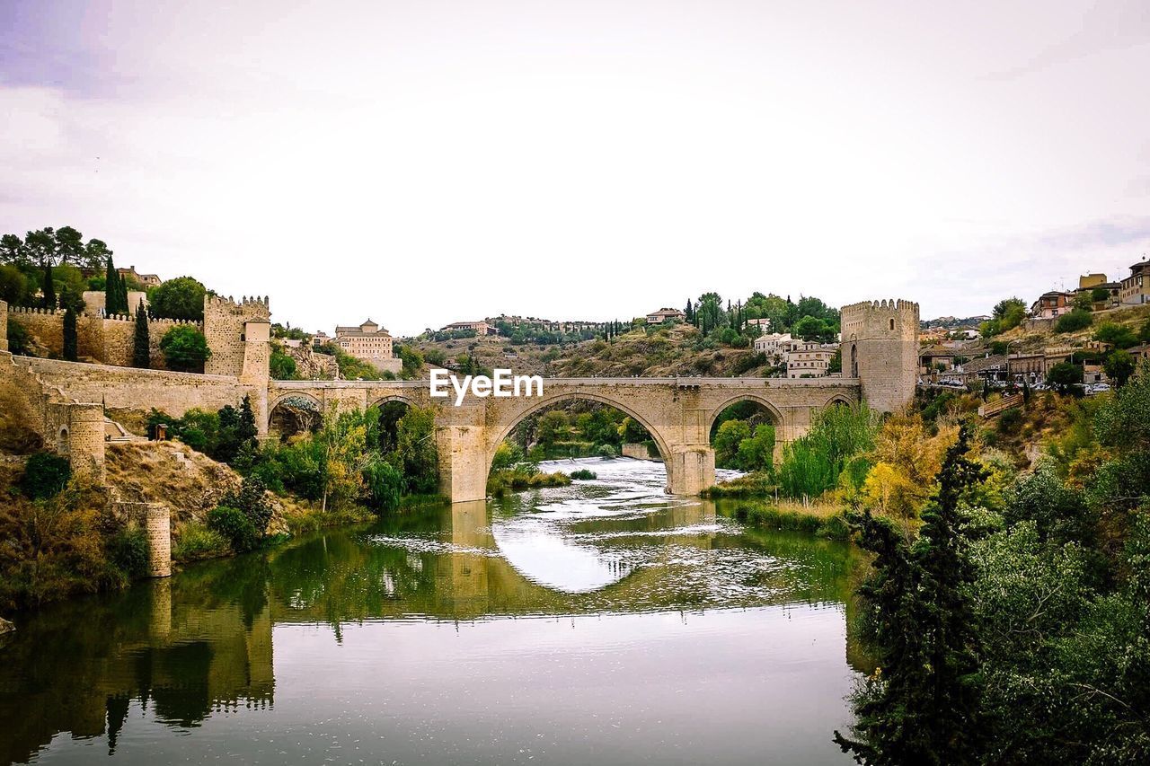 High angle view of old bridge over river against sky