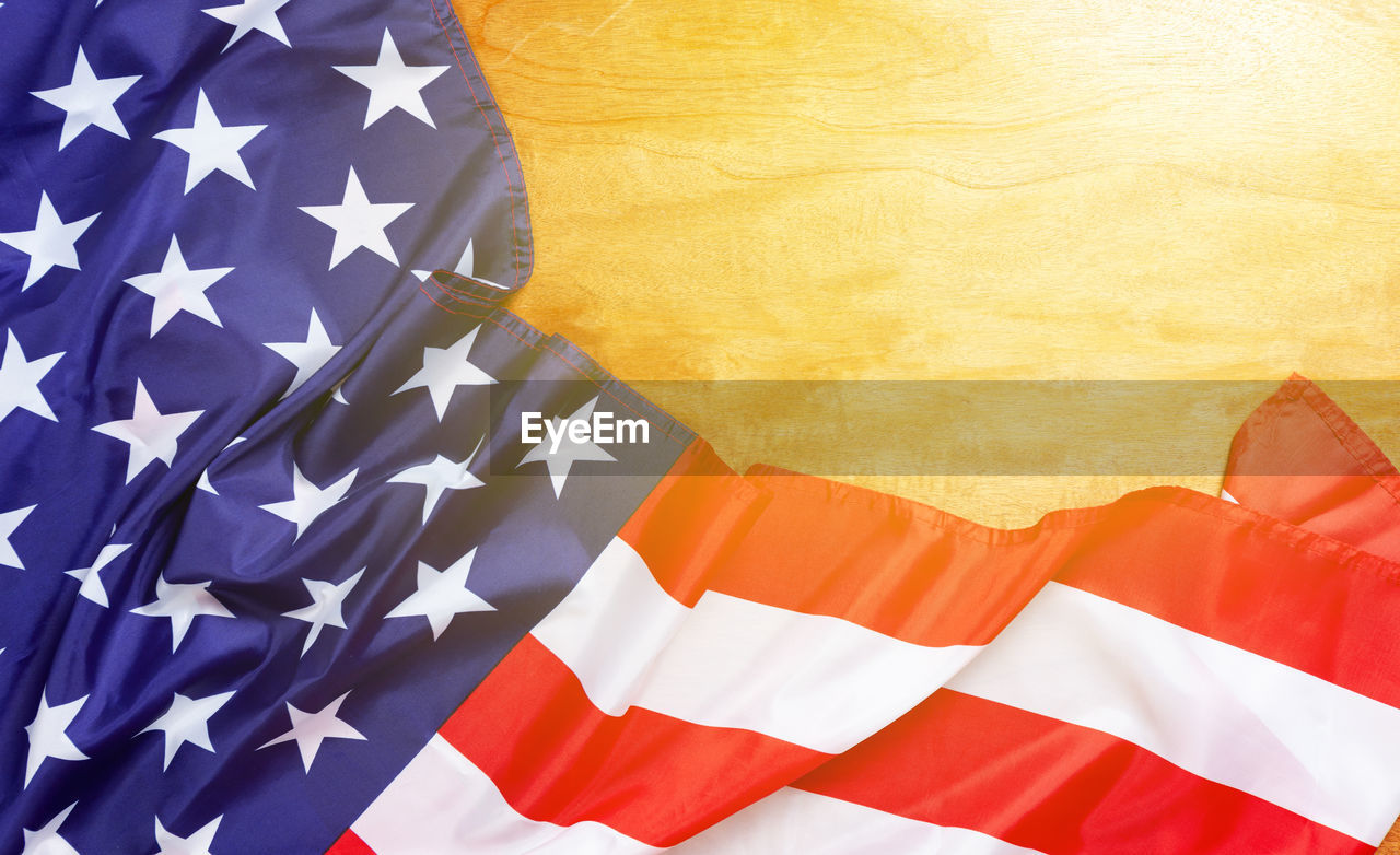 Close-up of american flag on wooden table