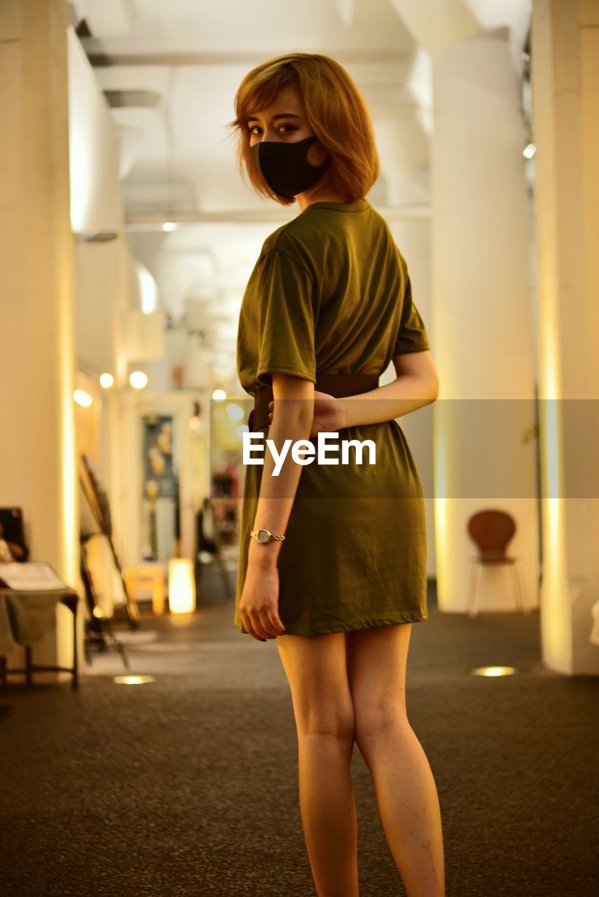Full length of woman standing in corridor