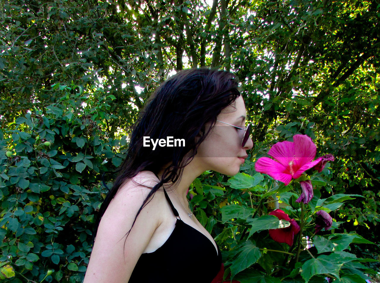 Woman smelling pink flower