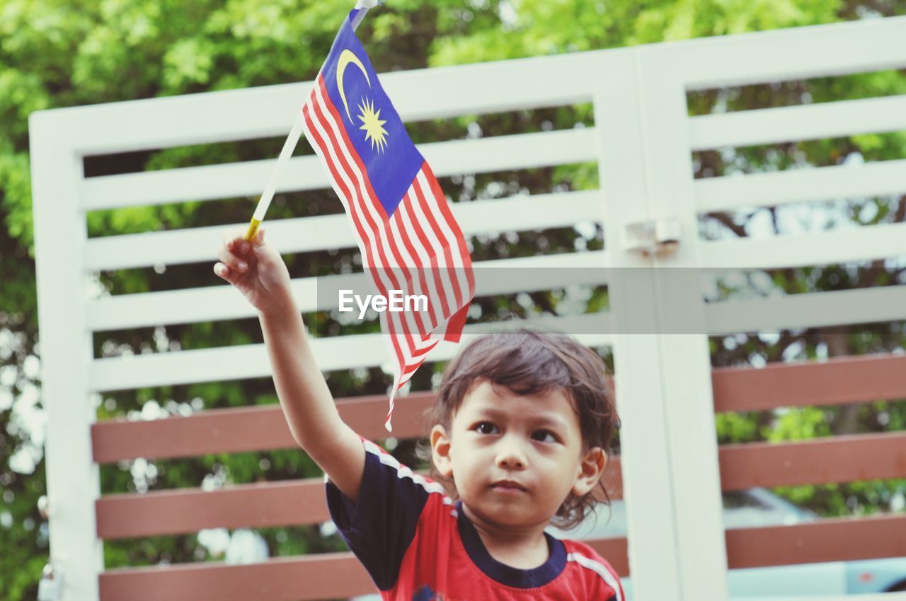 Boy holding malaysian flag