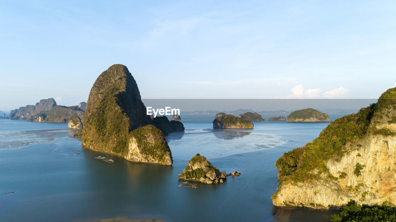 Scenic view of rock formation in sea against sky