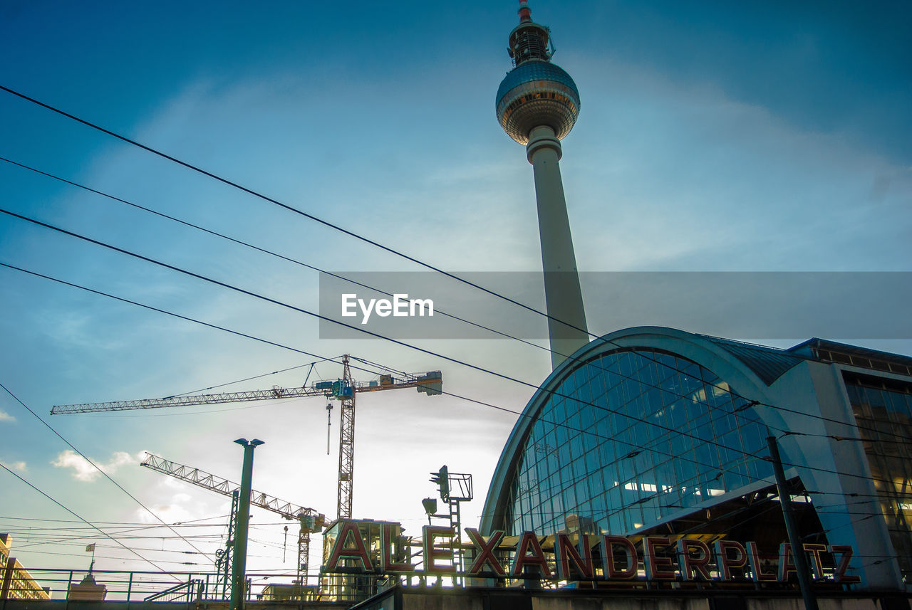 Low angle view of fernsehturm and alexanderplatz against sky