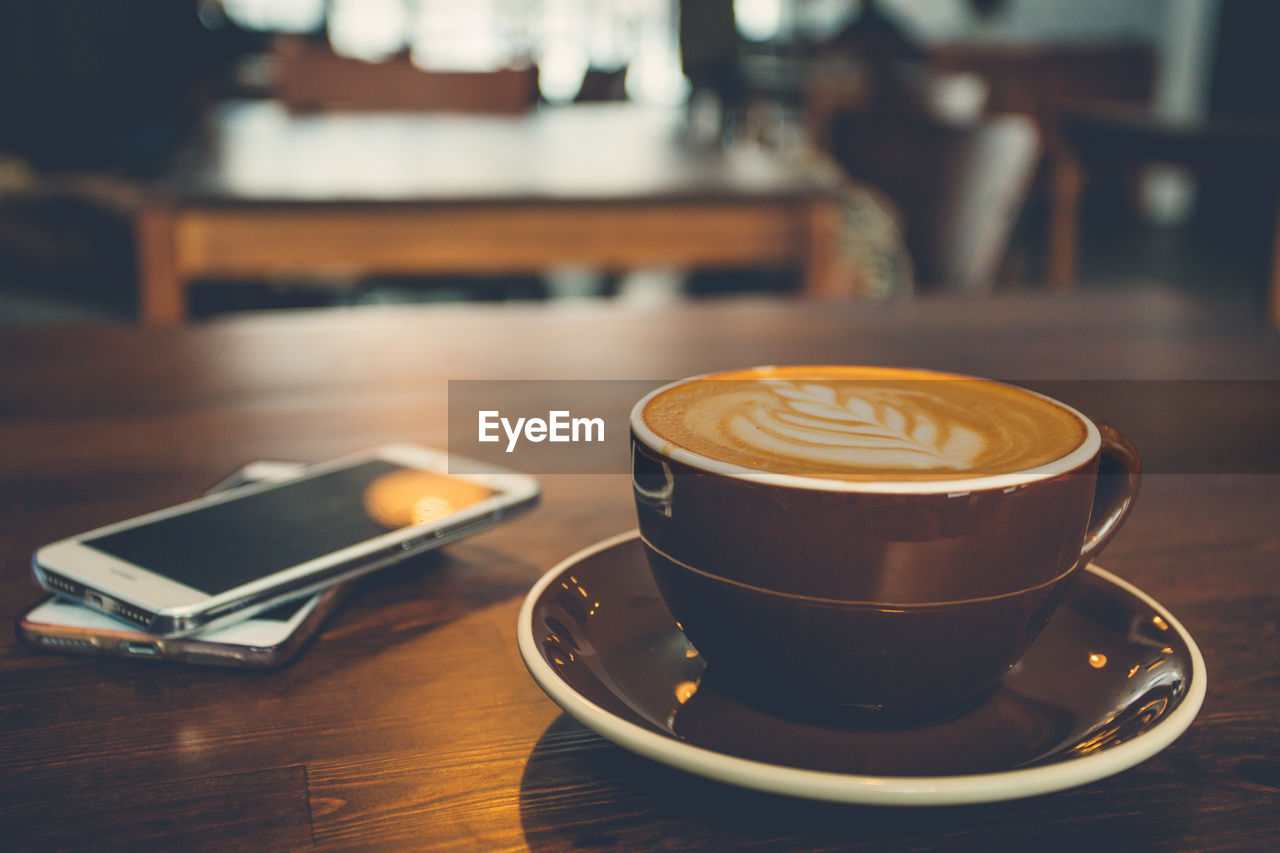 CLOSE-UP OF CAPPUCCINO ON TABLE