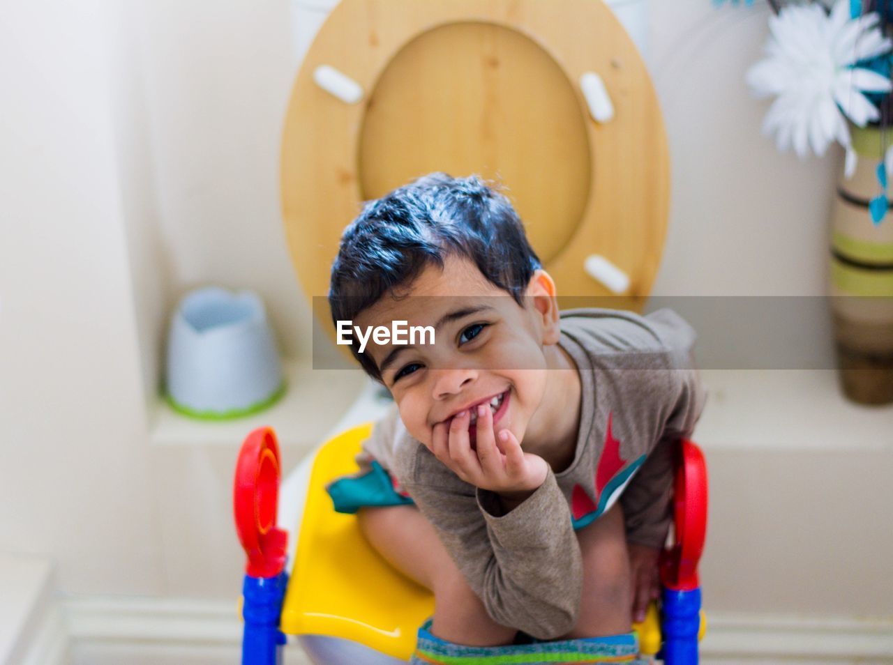 Boy sitting on toilet