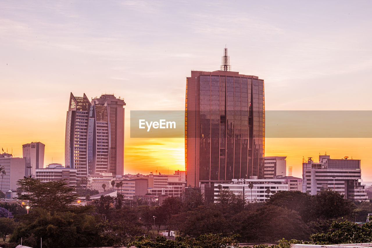 architecture, city, building exterior, built structure, building, office building exterior, skyscraper, landscape, sky, sunset, skyline, urban skyline, cityscape, nature, residential district, urban area, travel destinations, downtown district, office, metropolitan area, horizon, landmark, travel, business, dusk, downtown, city life, no people, business finance and industry, tower, cloud, outdoors, metropolis, evening, dramatic sky, tower block, sunlight, development, street, illuminated, tourism, twilight, scenics - nature, plant