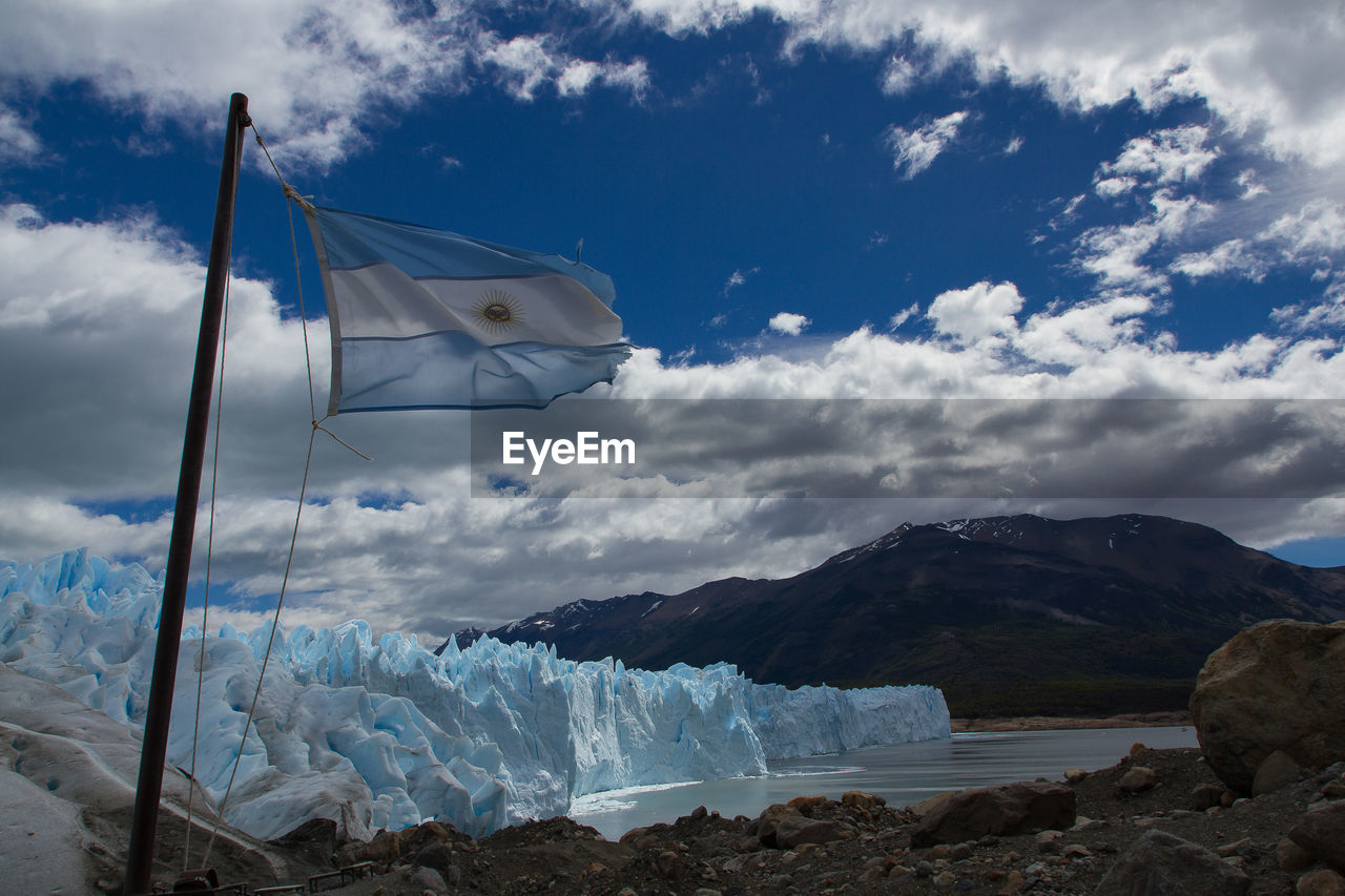 Scenic view of sea and mountains against sky