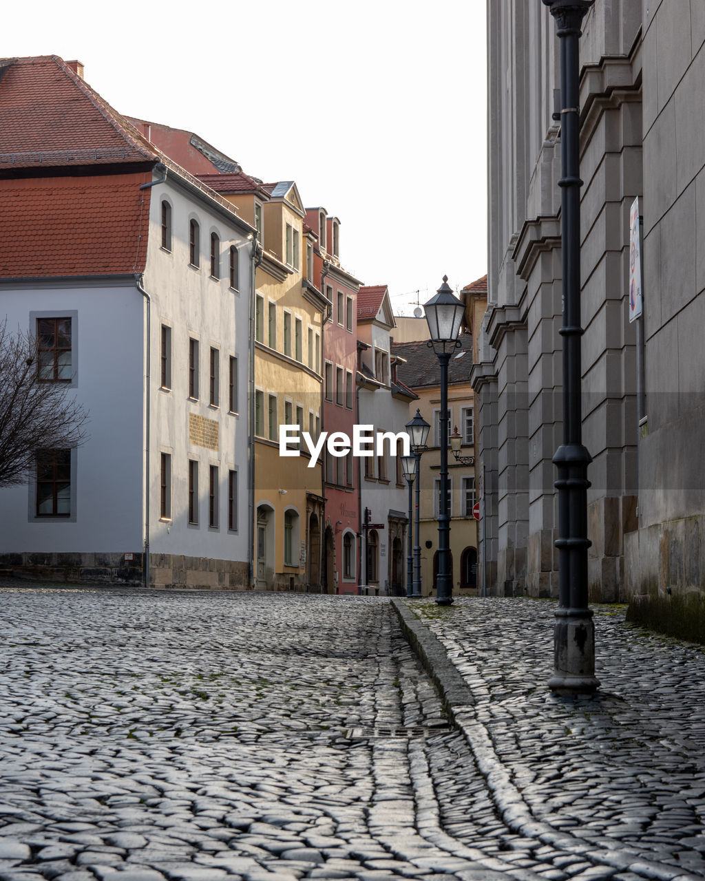 Street amidst buildings in town against sky