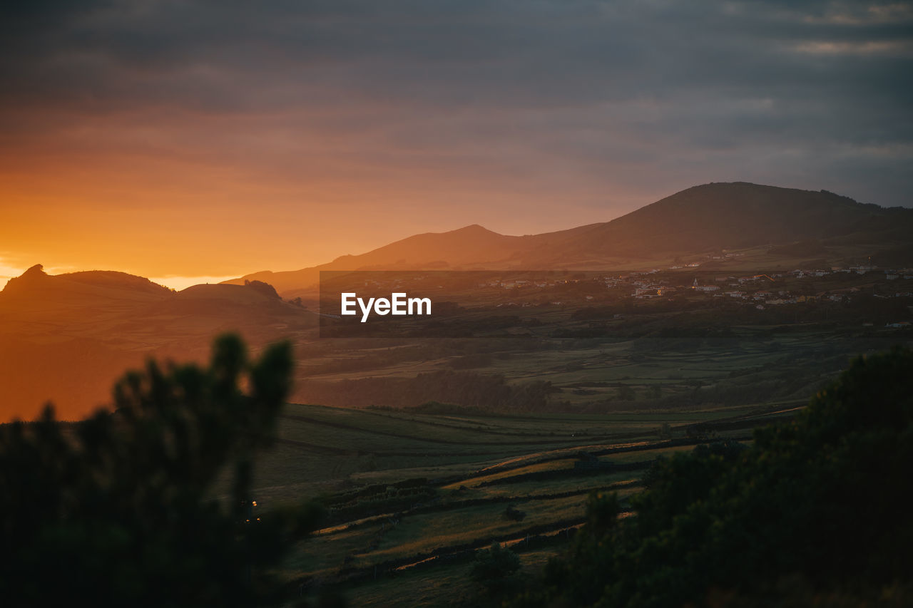 Scenic view of mountains against sky during sunset