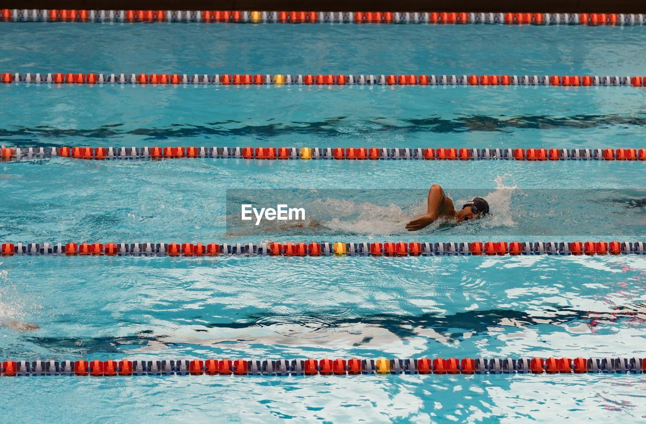 High angle view of teenage boy swimming pool