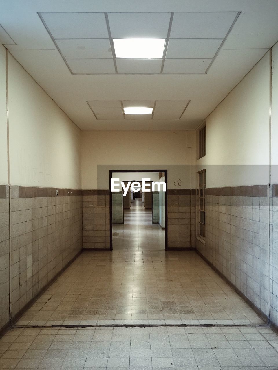 EMPTY NARROW CORRIDOR ALONG BUILDINGS