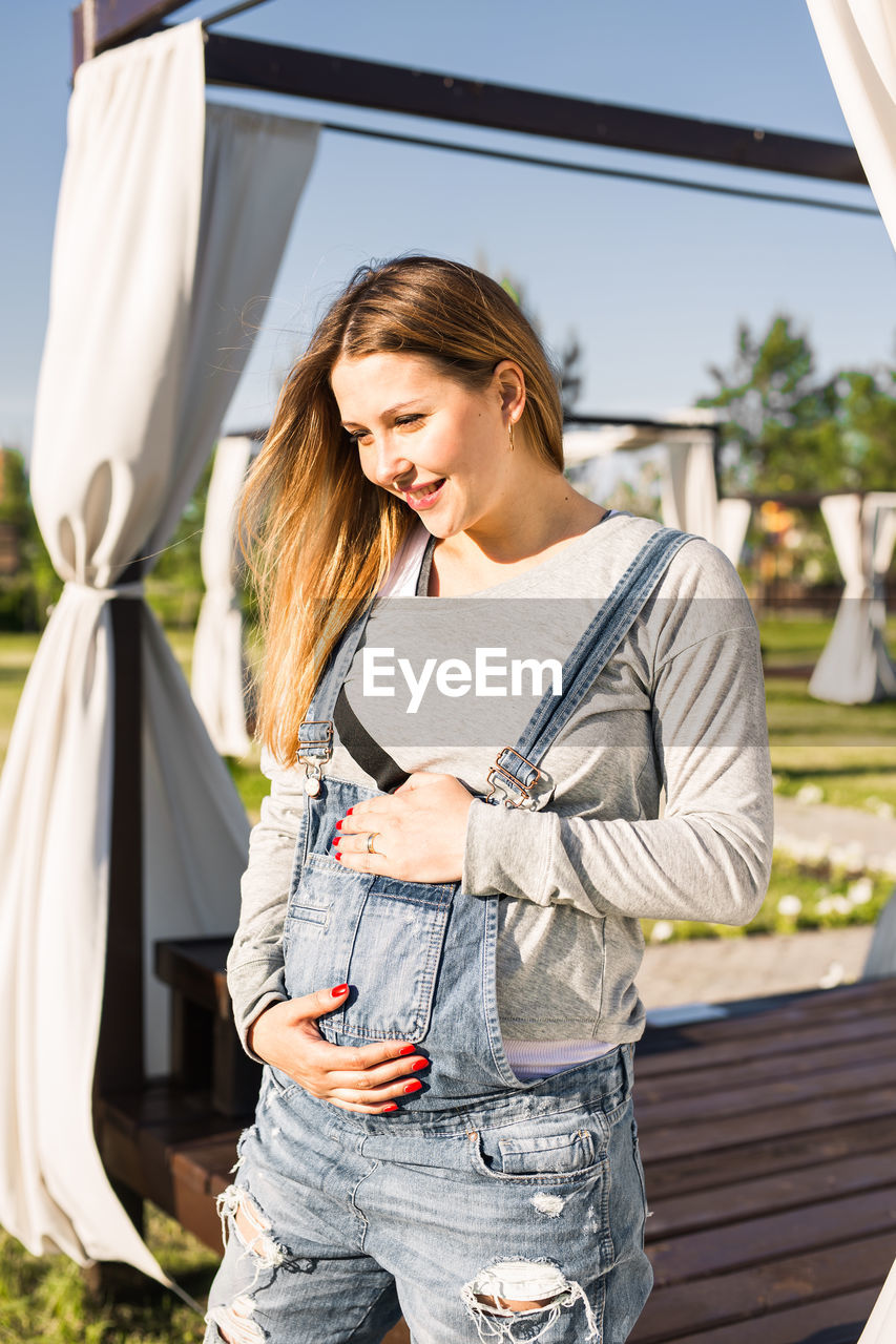 Pregnant woman standing outdoors