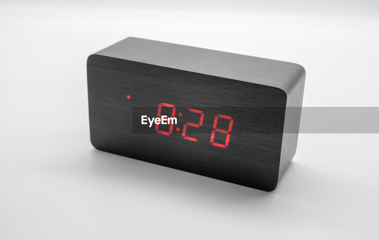 Close-up of digital clock on white background