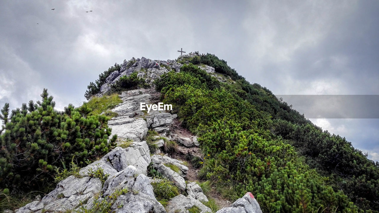 Low angle view of mountain against cloudy sky