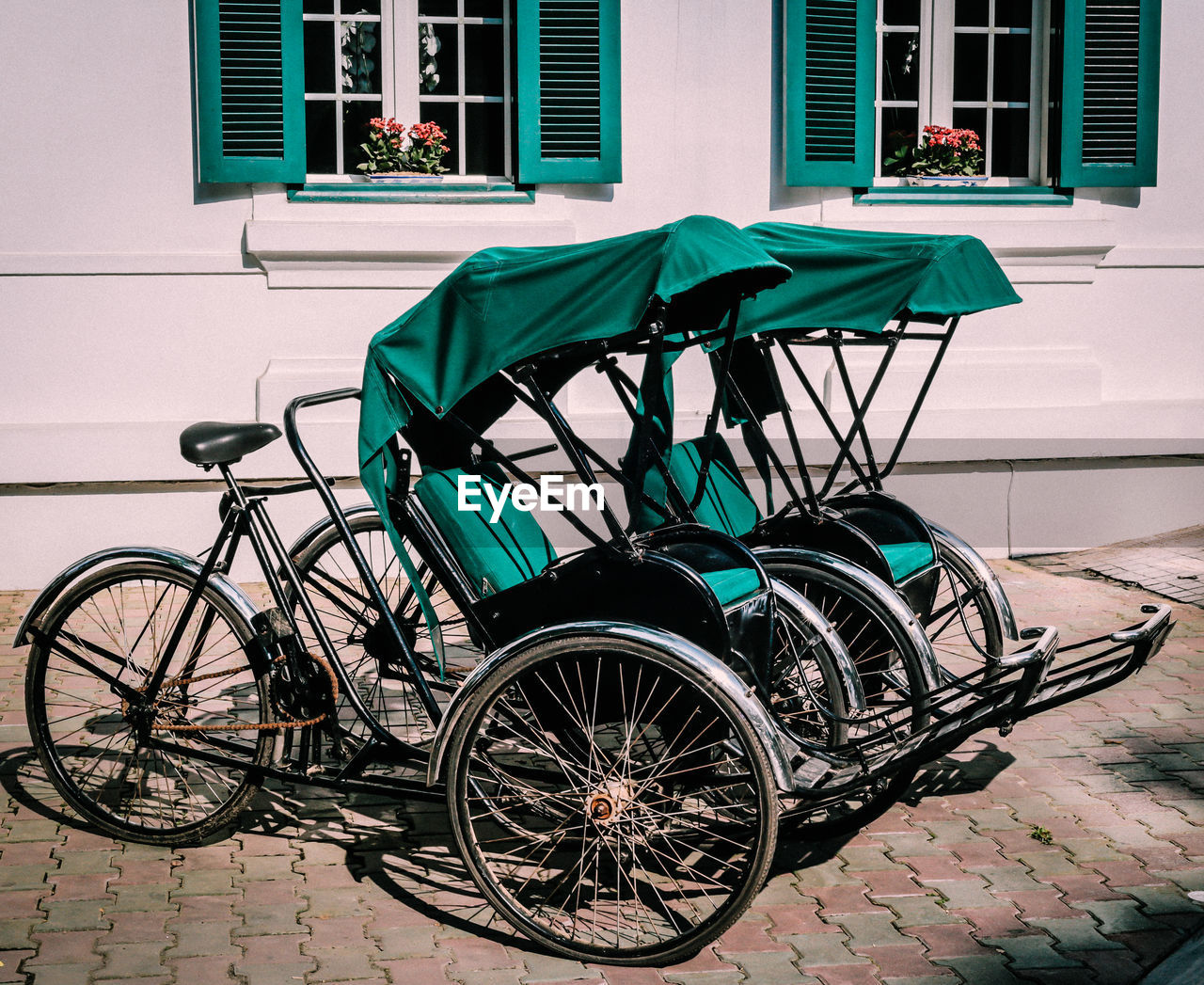 BICYCLE PARKED BY WINDOW