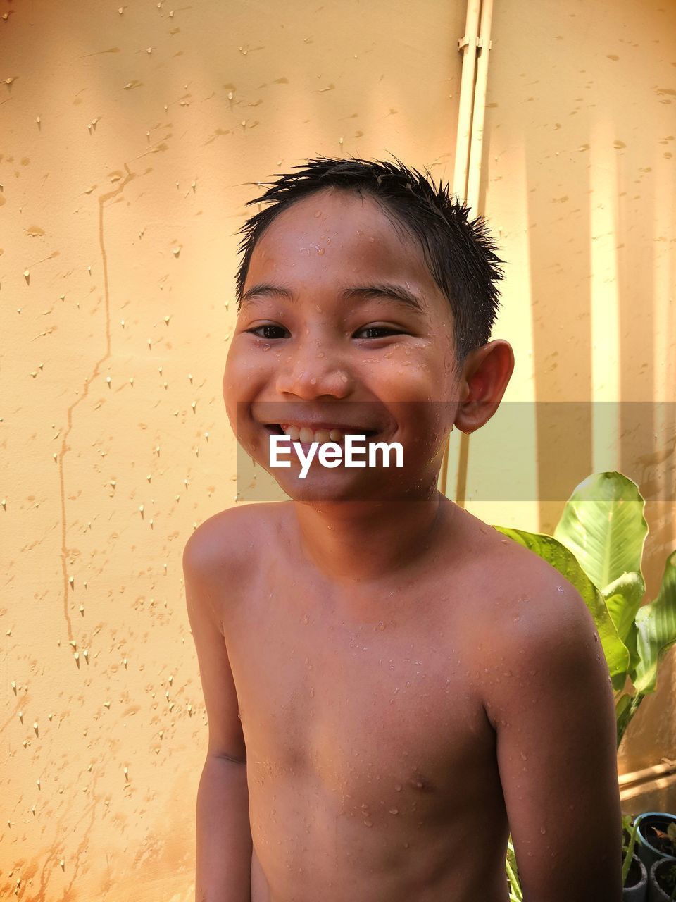 Portrait of smiling shirtless boy