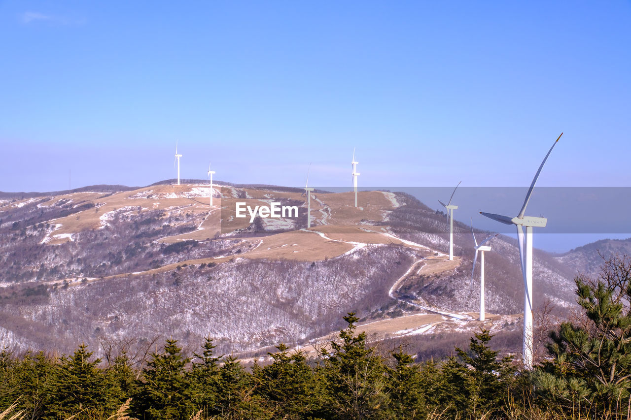 Scenic view of mountains against clear blue sky