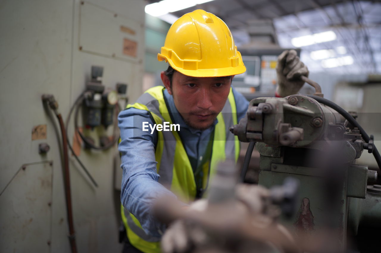 rear view of construction worker working at factory