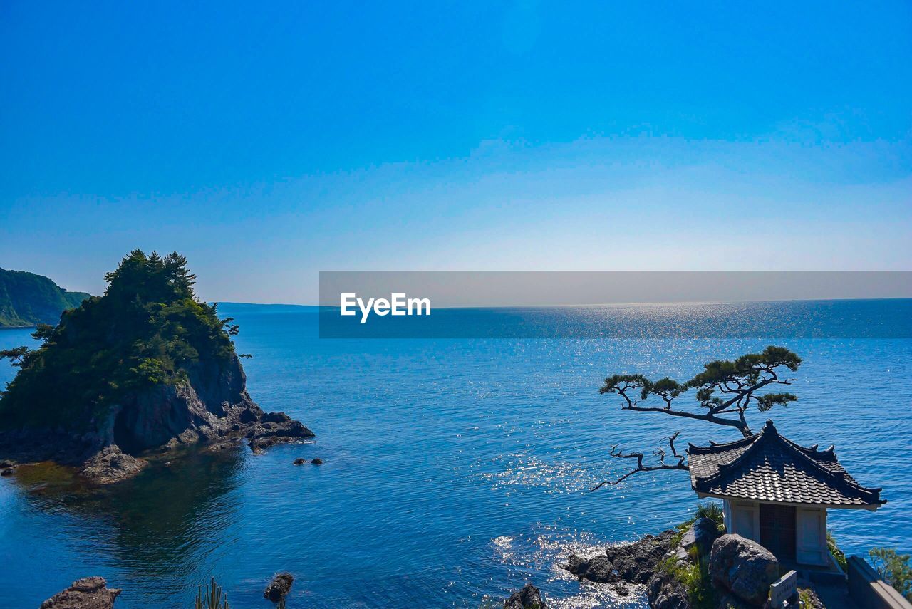 Scenic view of sea against clear blue sky