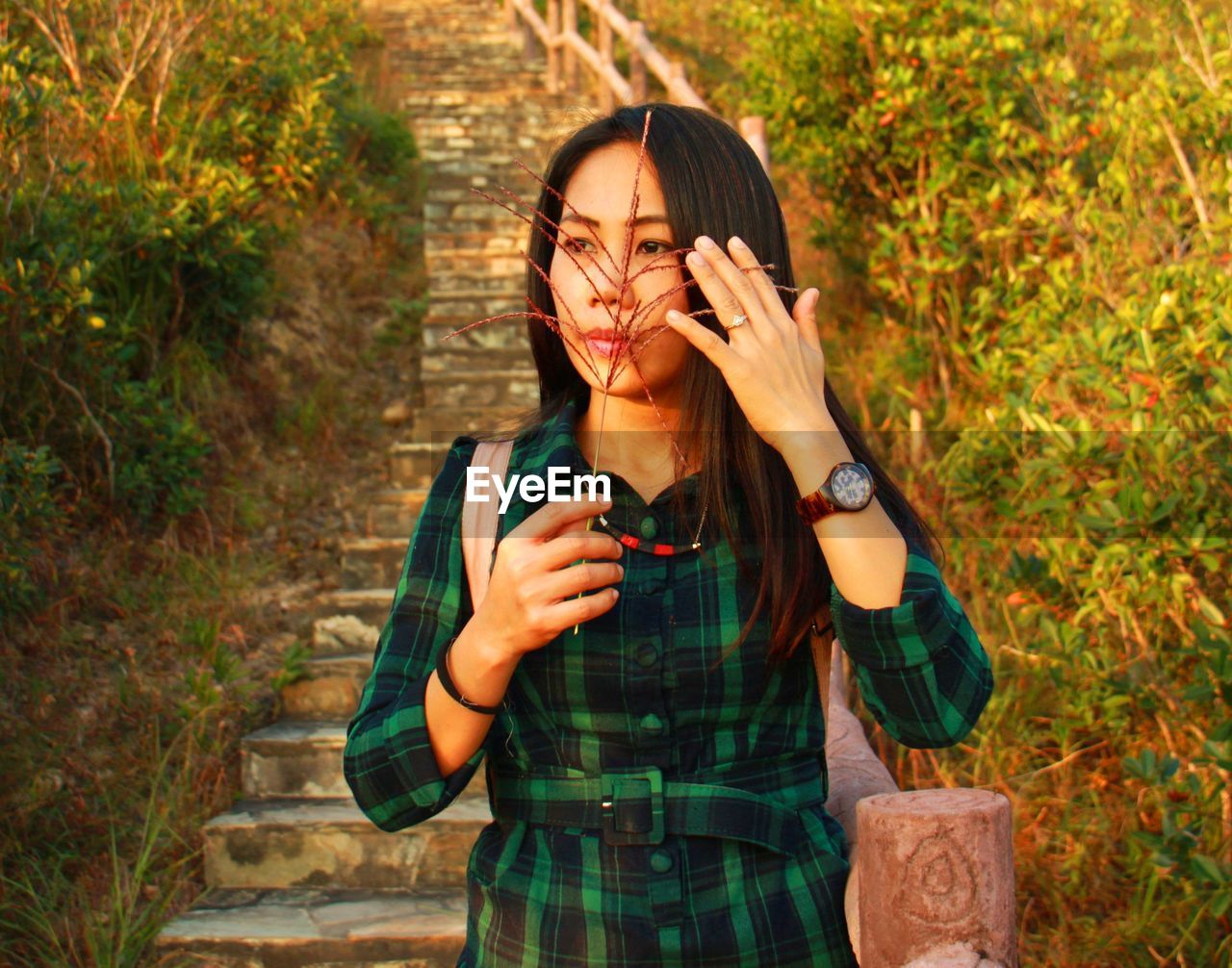 Portrait of beautiful young woman standing in park during autumn