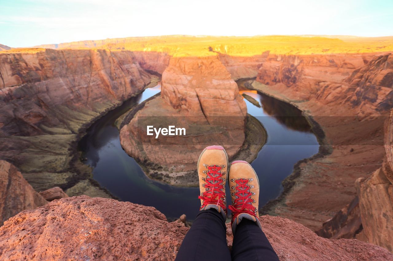 Low section of woman resting at horseshoe canyon