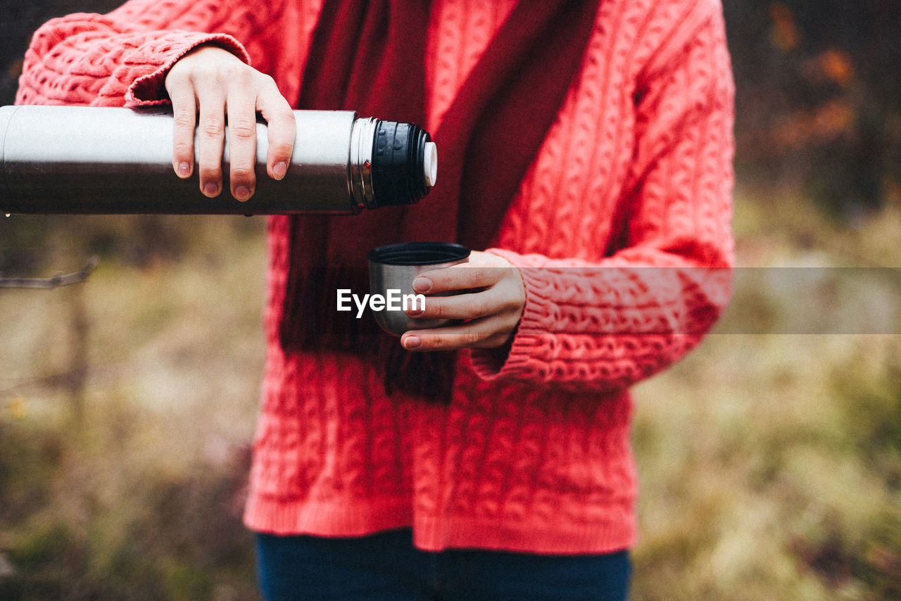 Woman drinking hot beverage outdoors