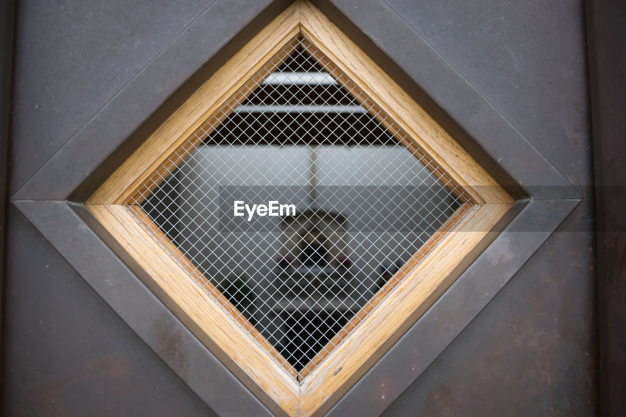 Close-up view trough window into little chapel