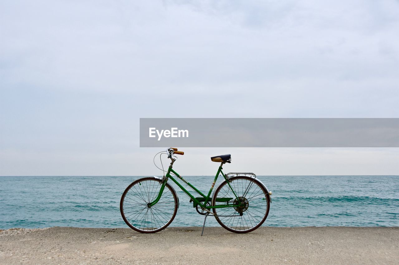 Bicycle on coast against sky