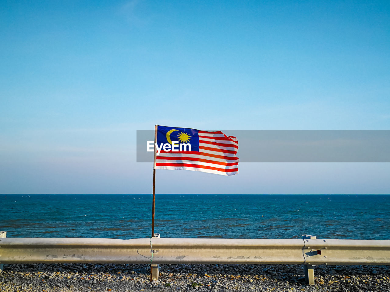 INFORMATION SIGN ON BEACH AGAINST SKY