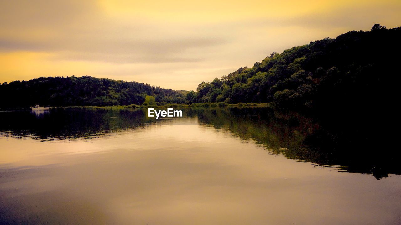 Scenic view of lake against sky during sunset