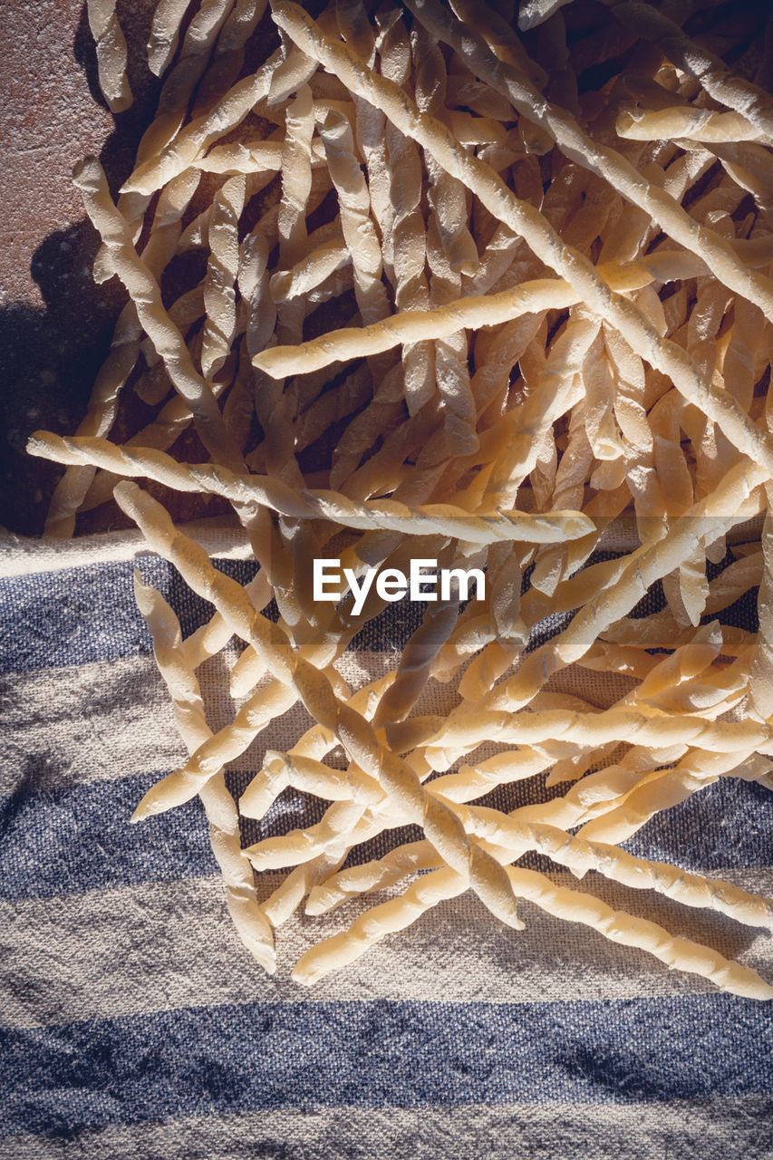 Homemade pasta lying on a wood cutting board