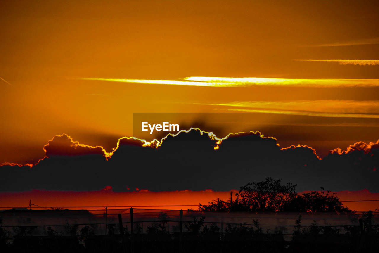 Scenic view of silhouette clouds against romantic sky at sunset