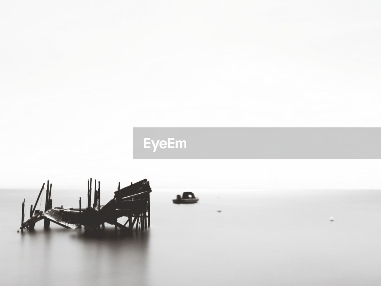 Scenic view of sea against clear sky with the remains of an old wooden dock