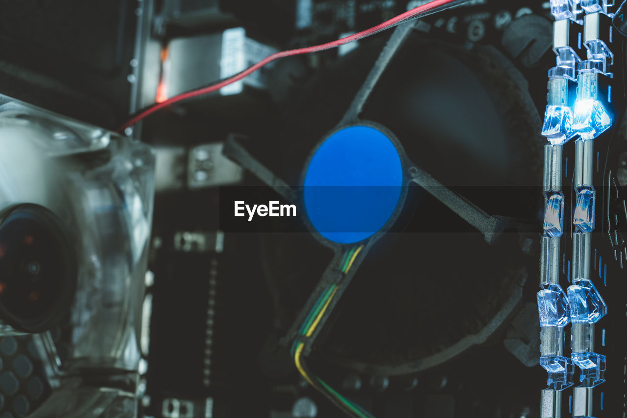 Ram memory in computer motherboard with blue light. inside desktop pc plenty of dust. pc system. 