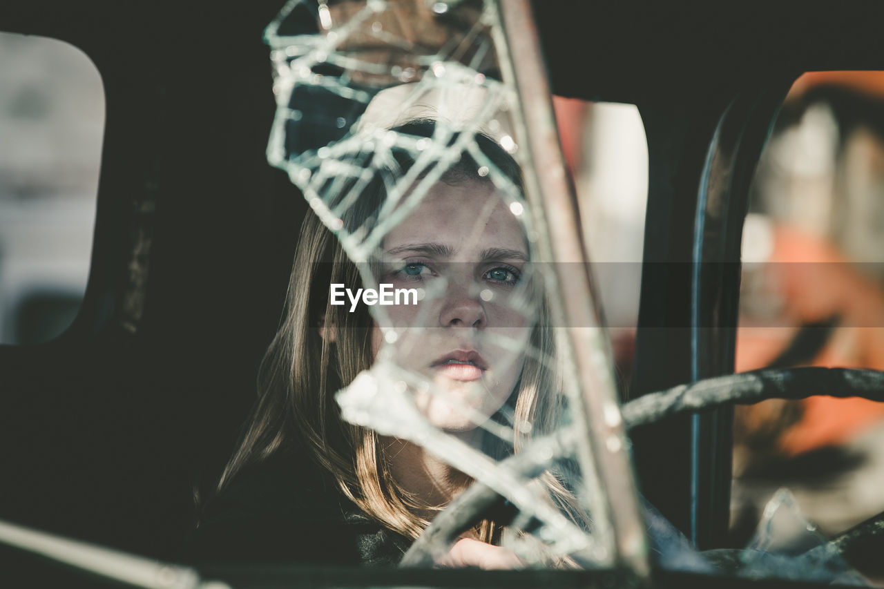 Close-up of woman in abandoned car