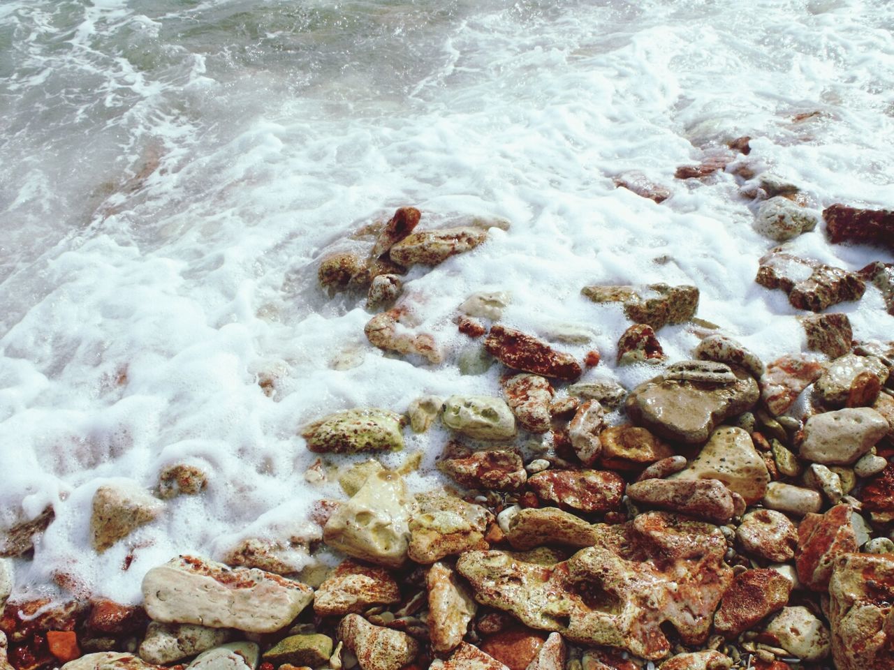 Close-up of pebble shore and sea