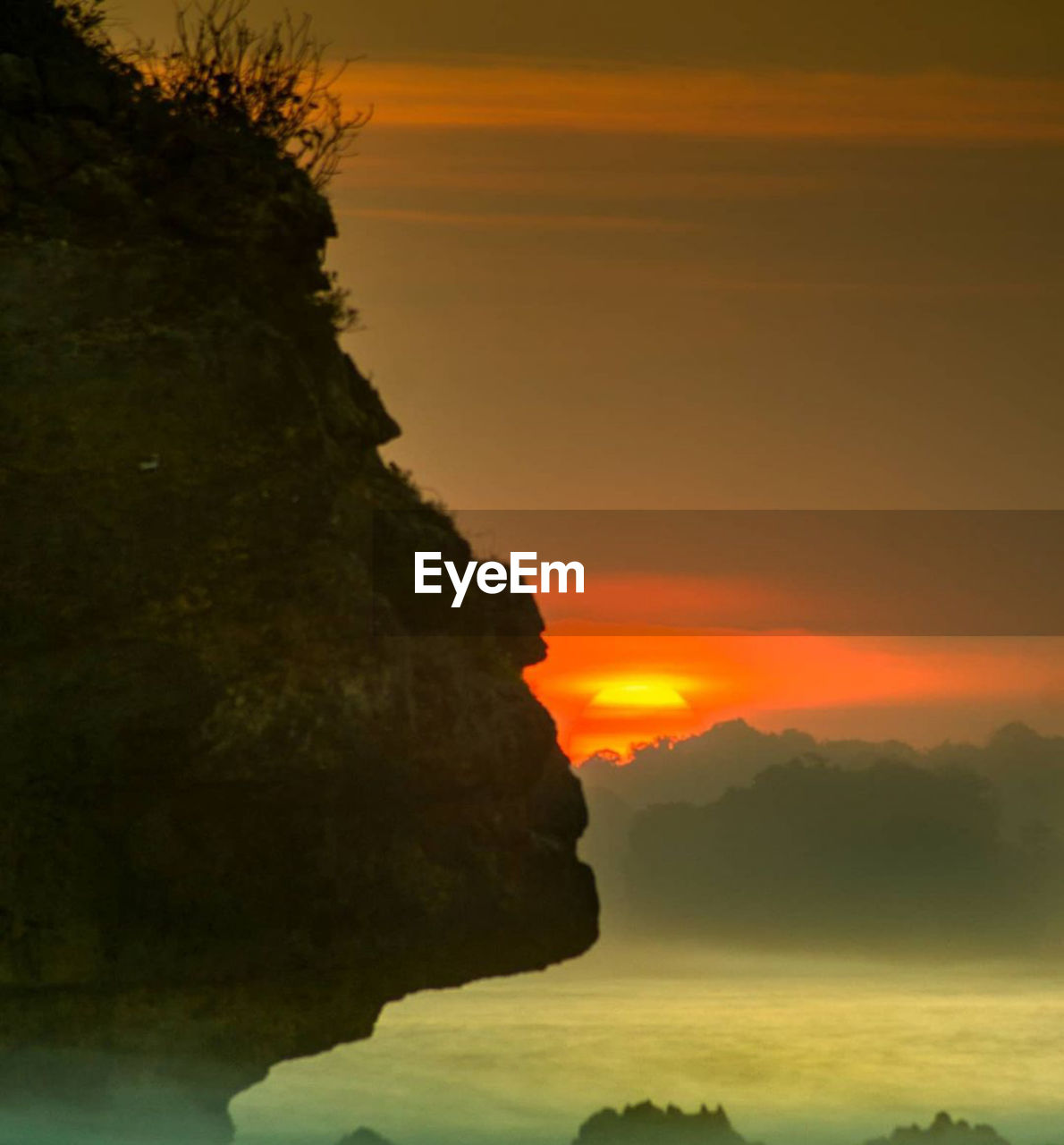 SCENIC VIEW OF ROCK FORMATION AGAINST SKY DURING SUNSET
