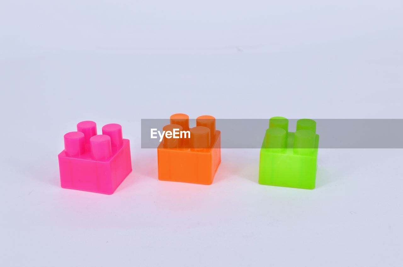 High angle view of colorful toy blocks against white background