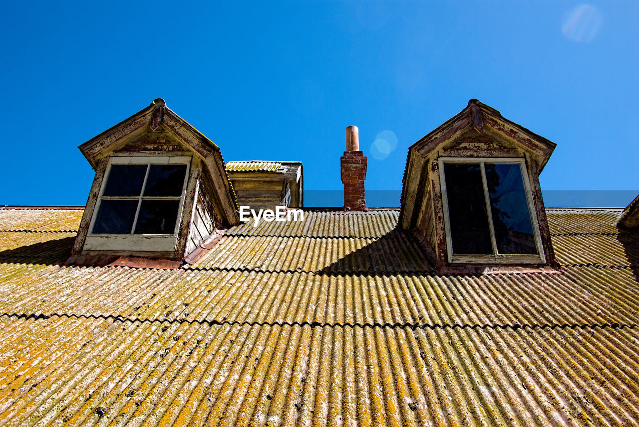 Low angle view of house against clear blue sky