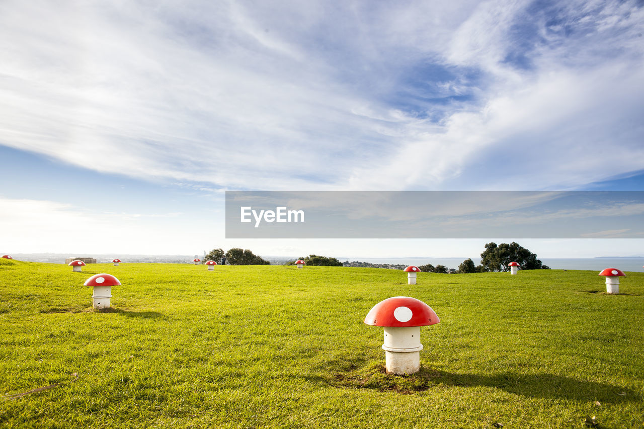 Scenic view of field against cloudy sky