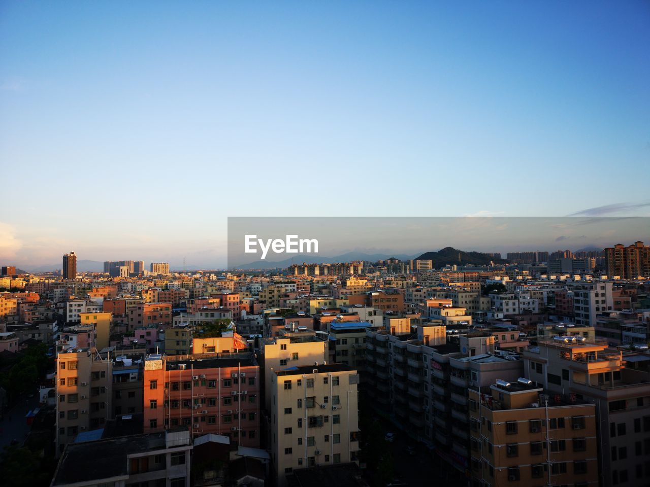 High angle view of buildings against clear blue sky