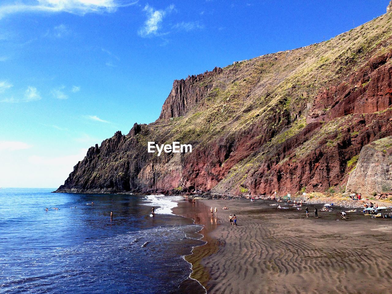 Scenic view of sea and mountains against sky